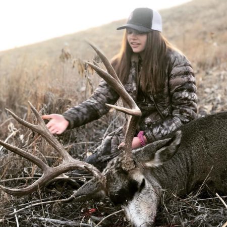 A girl with a great muley buck.